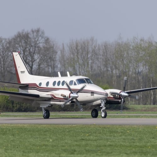 Twin-engined propeller business plane during landing at a small airport"n